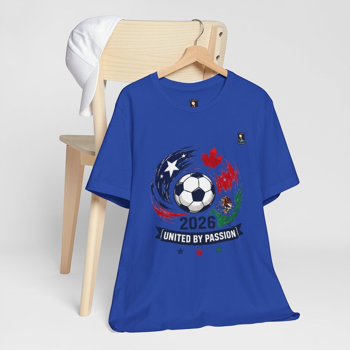 CJ Riders Foundation Store blue 100% cotton t-shirt with 2026 soccer graphic featuring a ball, USA, Canada, Mexico accents.