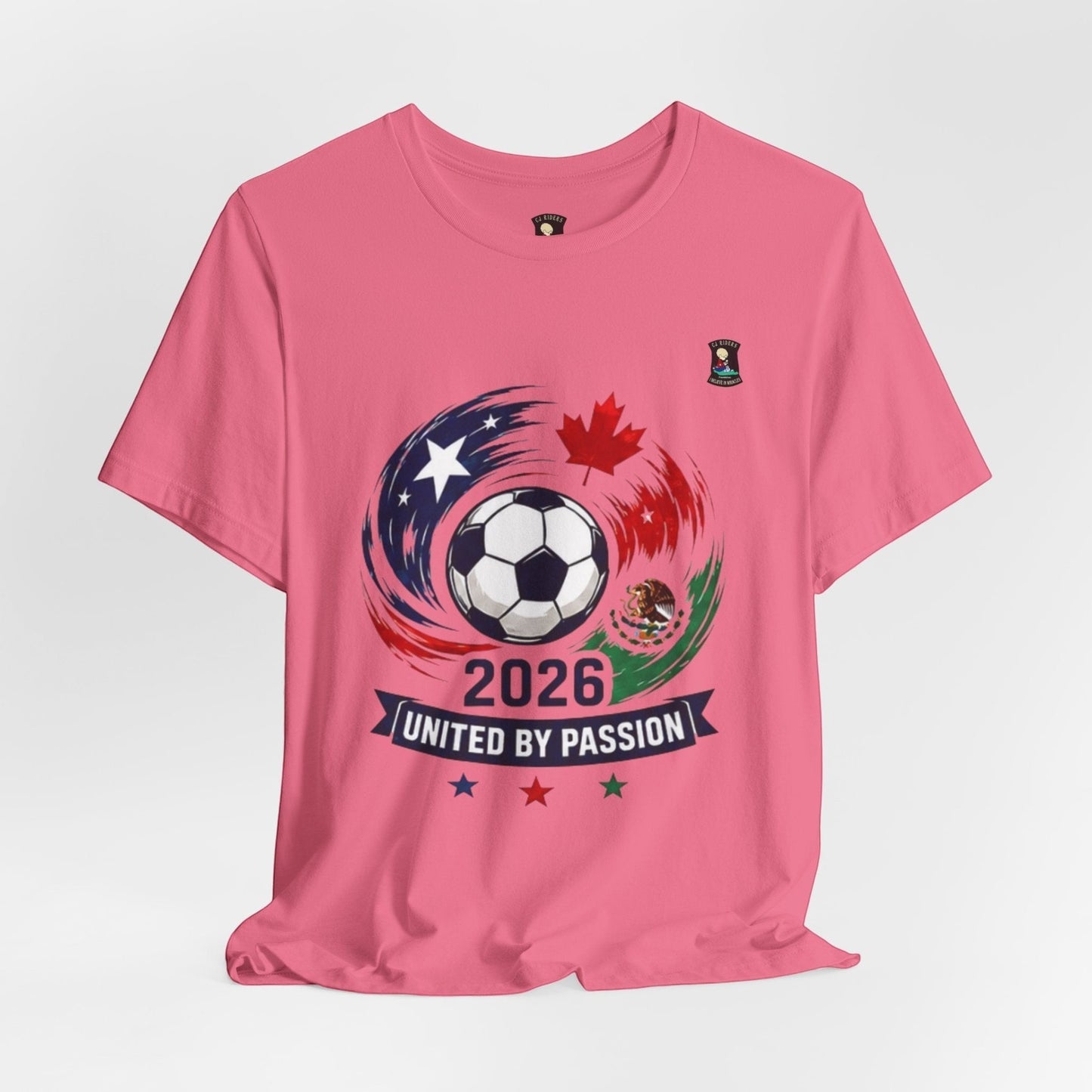 CJ Riders Foundation Store pink cotton t-shirt with 2026 soccer graphic featuring USA, Canada, Mexico flags and text "United by Passion"