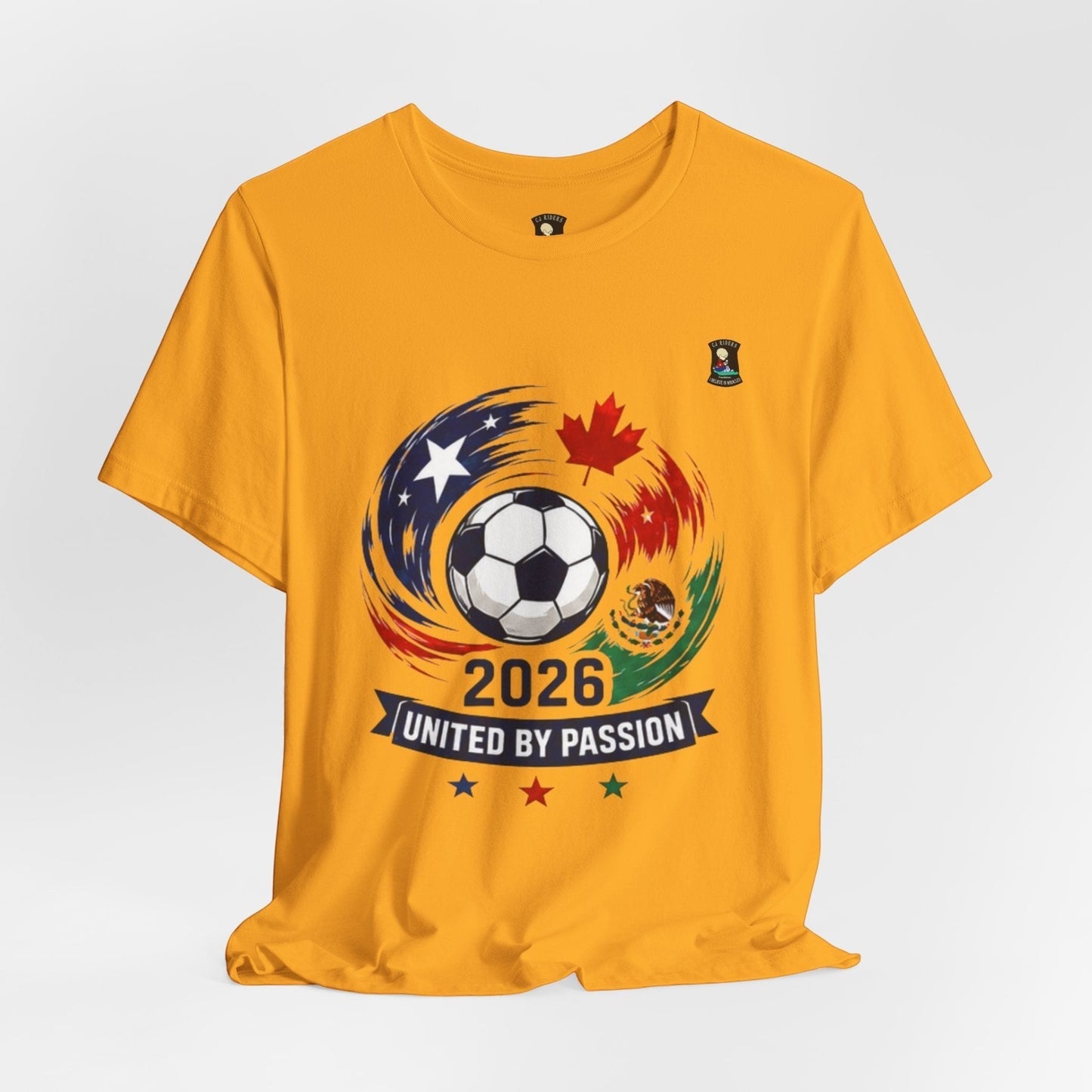 CJ Riders Foundation Store yellow 100% cotton t-shirt with 2026 soccer graphic featuring a ball, USA, Canada, Mexico flags, and "United by Passion" text.