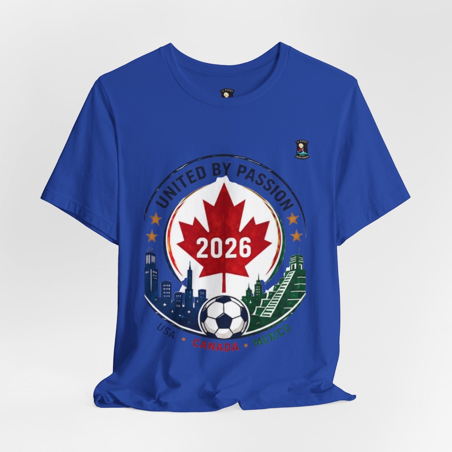 CJ Riders Foundation Store blue cotton t-shirt with 2026 soccer graphic featuring Canadian maple leaf, soccer ball, and city skylines.