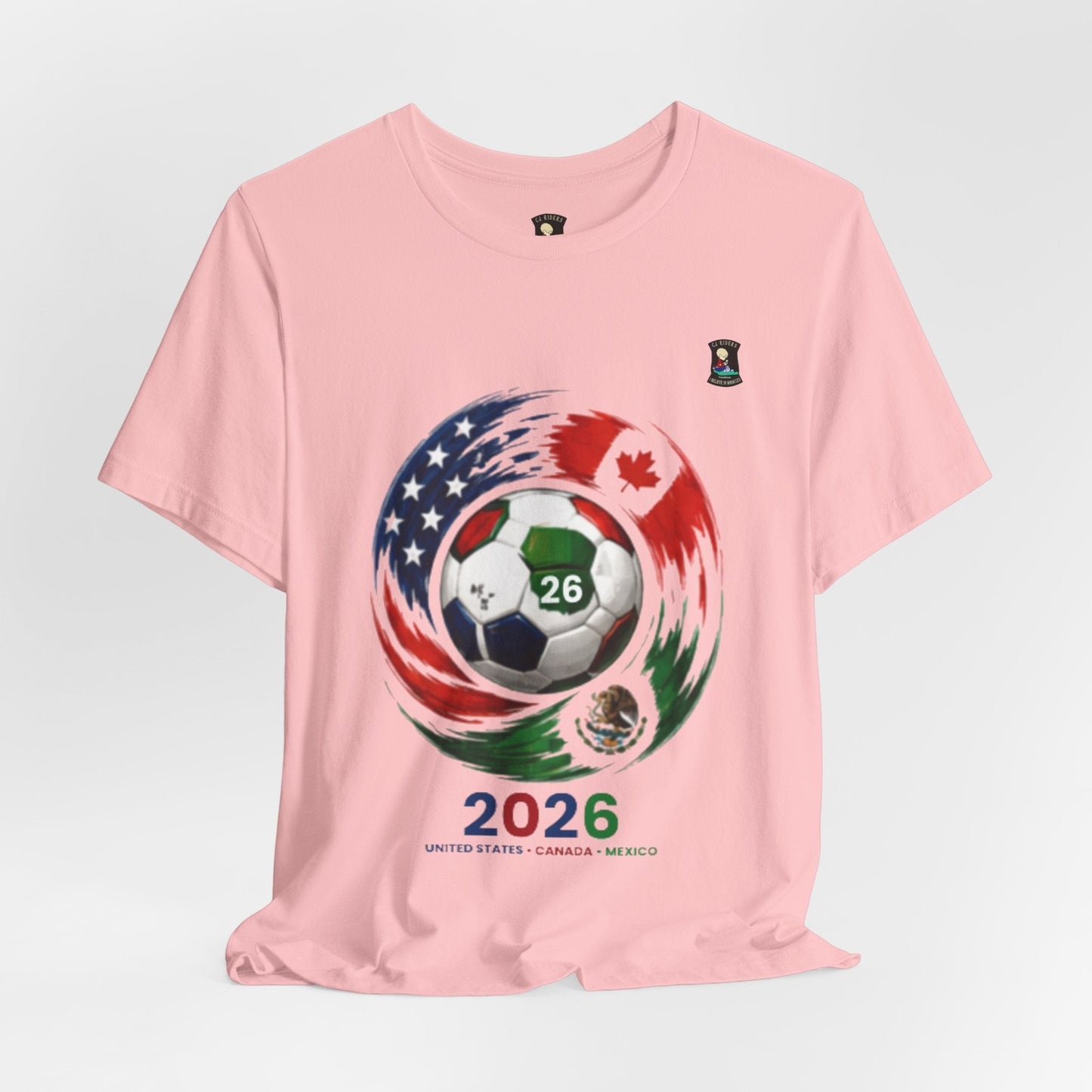 CJ Riders Foundation Store pink cotton t-shirt with 2026 World Cup graphic featuring a soccer ball and flags of USA, Canada, and Mexico.