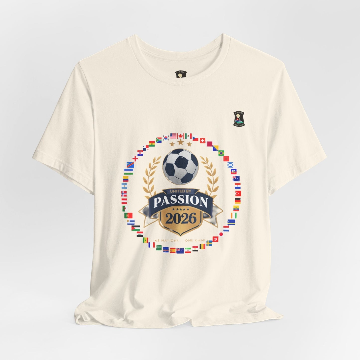 CJ Riders Foundation Store cream 100% cotton t-shirt with 2026 World Cup graphic featuring flags, soccer ball, and "United by Passion" text.