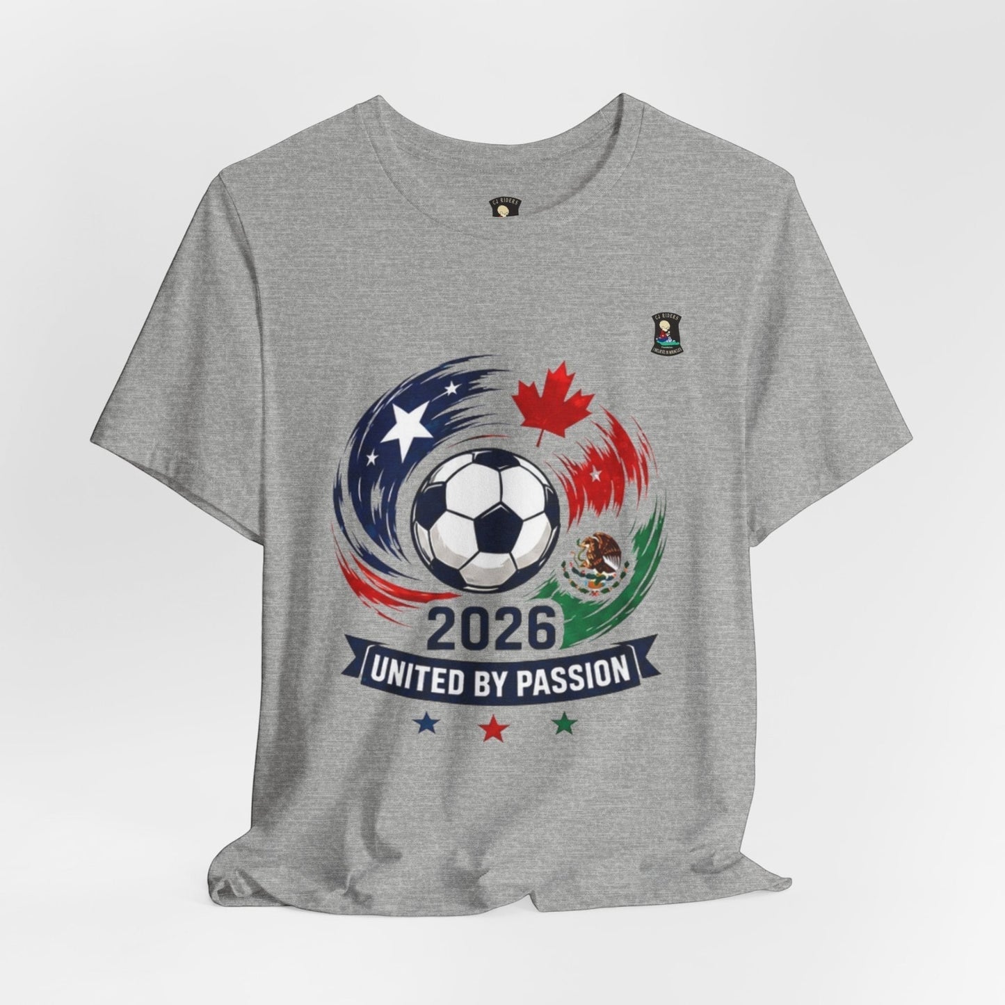 CJ Riders Foundation Store grey 100% cotton t-shirt with 2026 soccer graphic featuring USA, Canada, Mexico flags and "United by Passion" text.