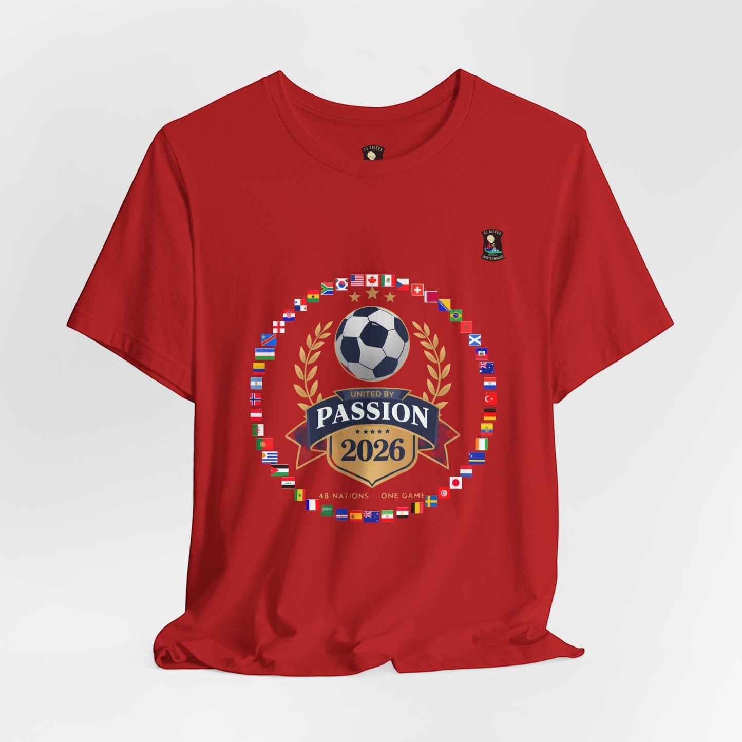 CJ Riders Foundation Store red 100% cotton t-shirt with 2026 World Cup graphic featuring flags, soccer ball, and "United by Passion" text.