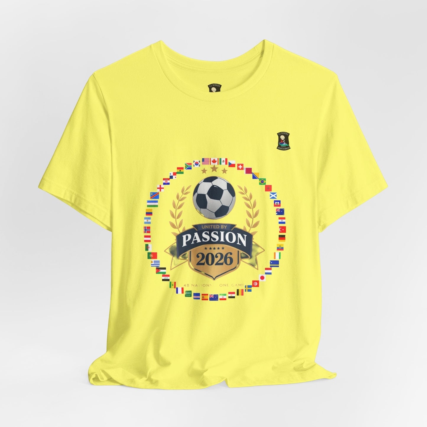 CJ Riders Foundation Store yellow 100% cotton t-shirt with 2026 World Cup graphic featuring flags, soccer ball, and "United by Passion" text.