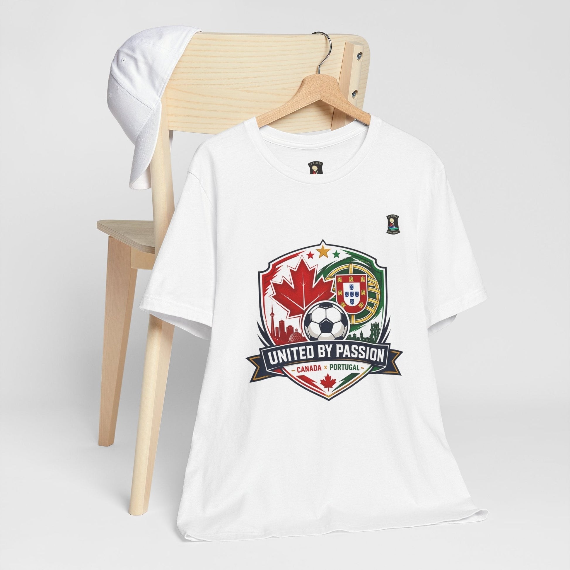 CJ Riders Foundation Store white 100% cotton t-shirt with Canada & Portugal soccer badge graphic. Features "United by Passion" text.
