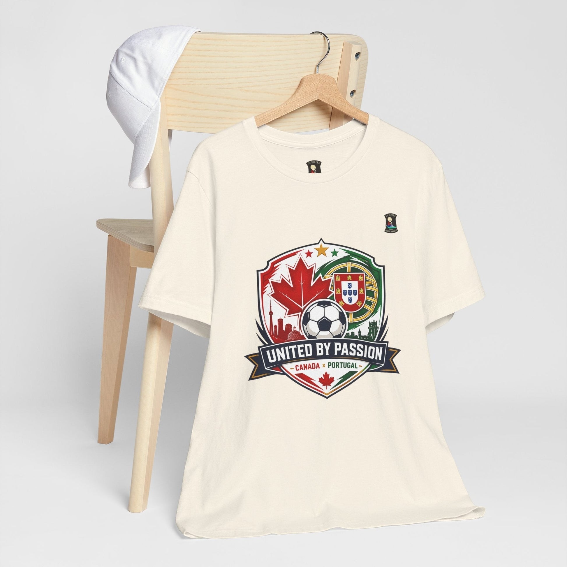 CJ Riders Foundation Store cream 100% cotton t-shirt with Canada & Portugal soccer badge graphic.