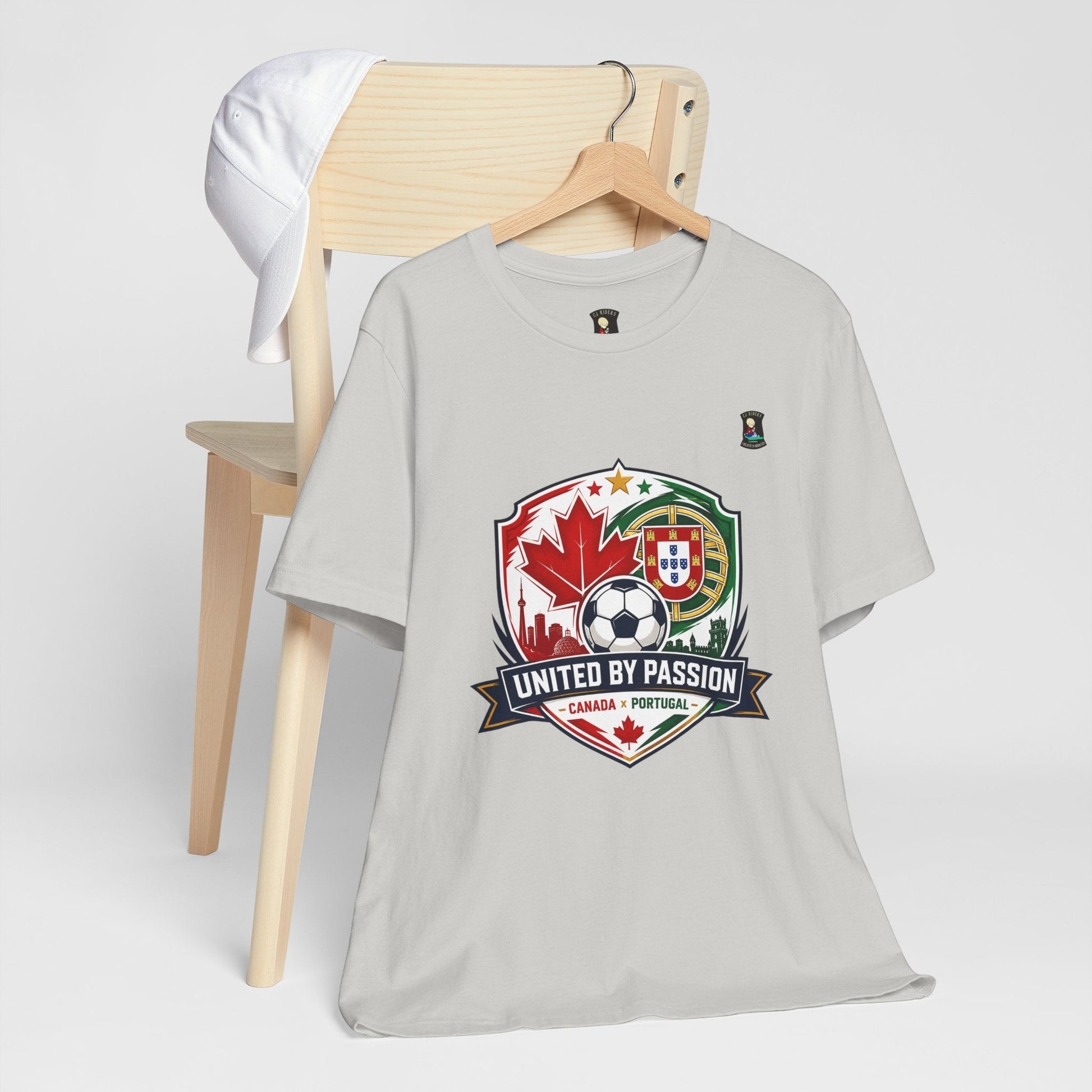 CJ Riders Foundation Store light grey 100% cotton soccer t-shirt with Canada & Portugal United by Passion 2026 graphic.