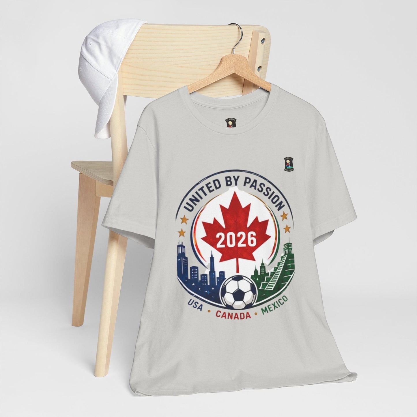 CJ Riders Foundation Store light grey 100% cotton t-shirt with a soccer crest design for the 2026 World Cup