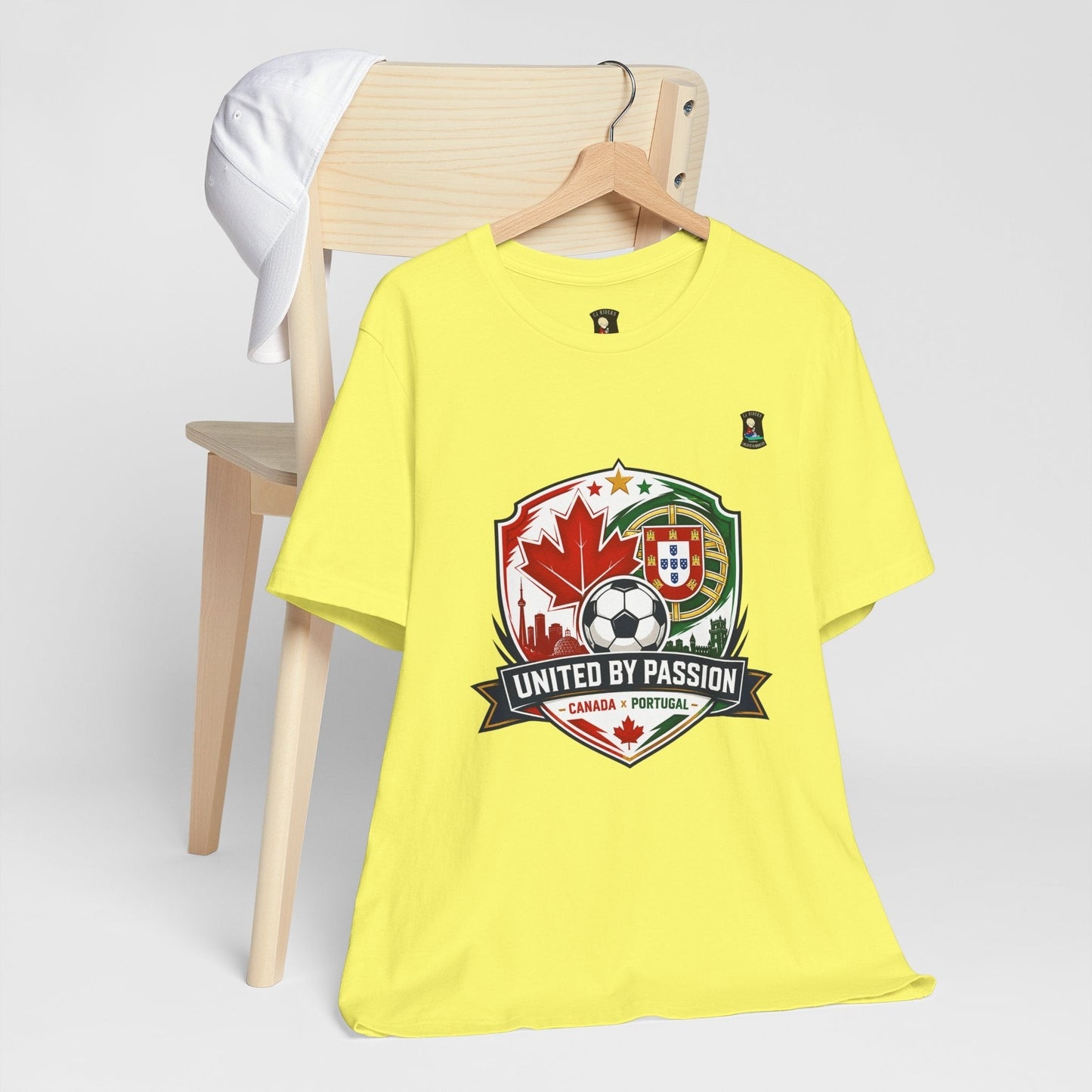 CJ Riders Foundation Store yellow 100% cotton soccer t-shirt with Canada & Portugal United by Passion 2026 graphic.