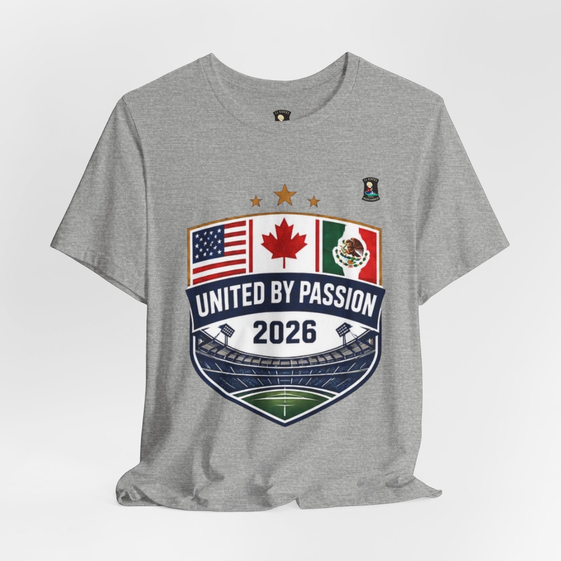 CJ Riders Foundation Store grey 100% cotton t-shirt with shield design featuring USA, Canada, Mexico flags and "United by Passion 2026" text.