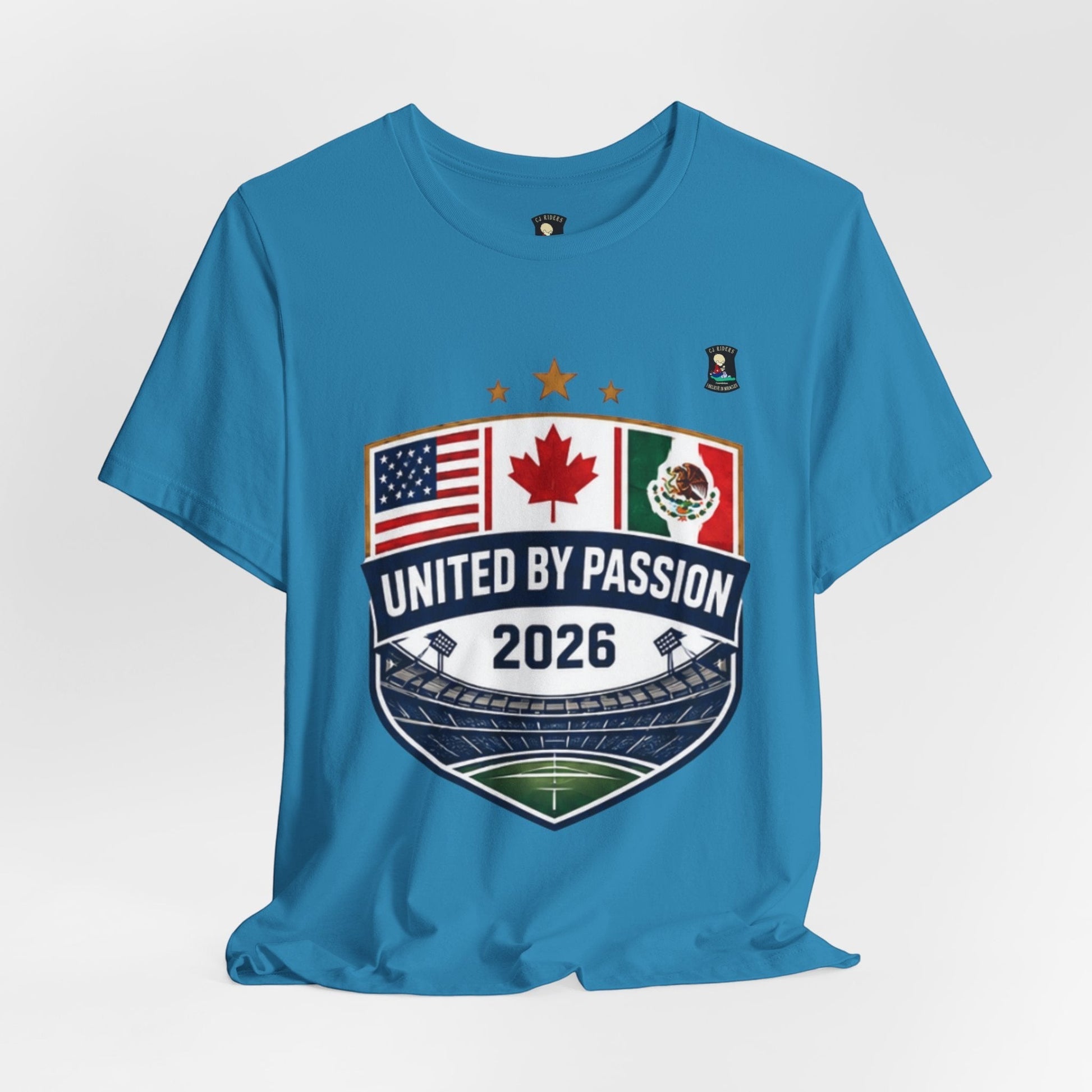 CJ Riders Foundation Store blue 100% cotton t-shirt with United by Passion 2026 shield graphic featuring USA, Canada, Mexico flags and stadium.