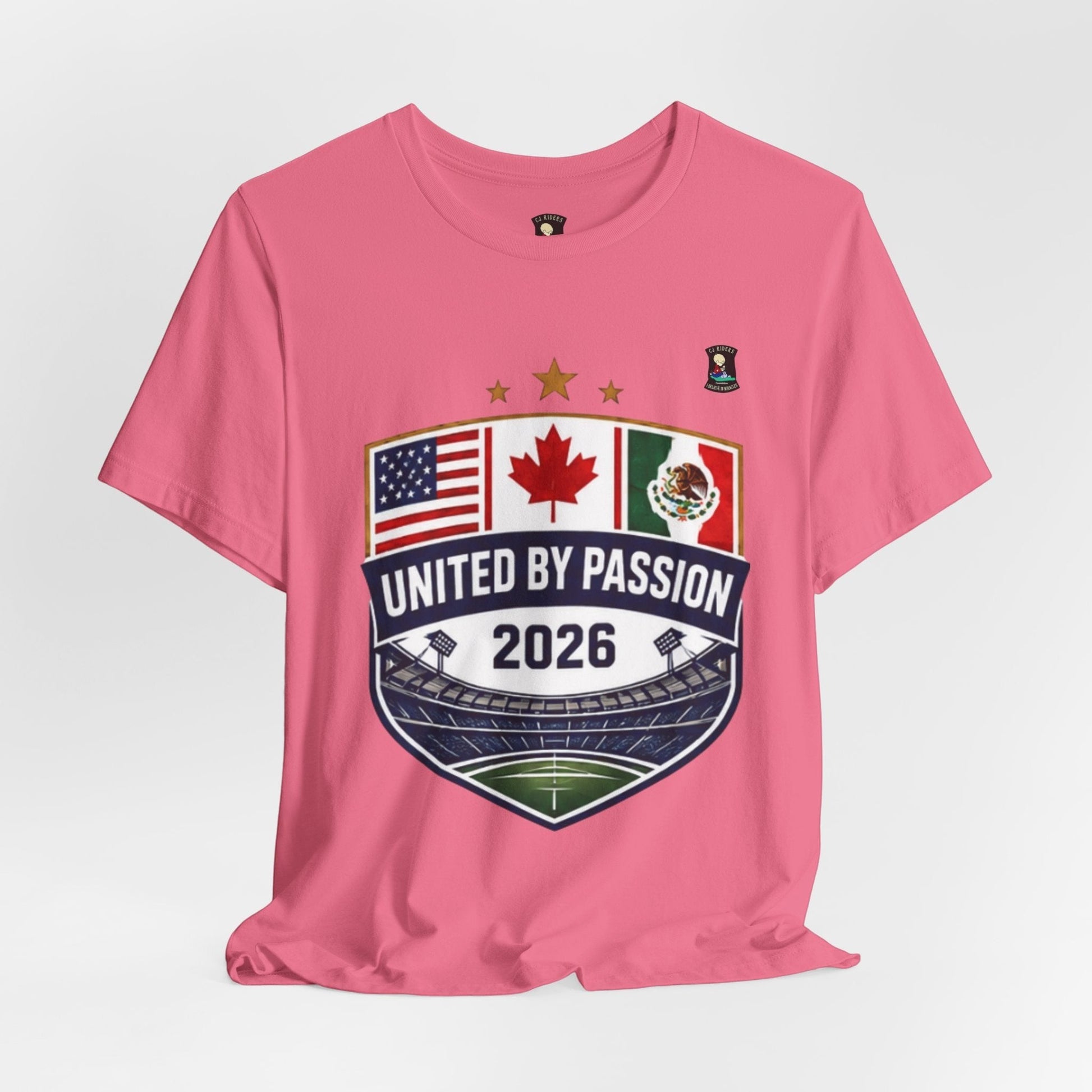 CJ Riders Foundation Store pink 100% cotton t-shirt with United by Passion 2026 shield design featuring USA, Canada, and Mexico flags.