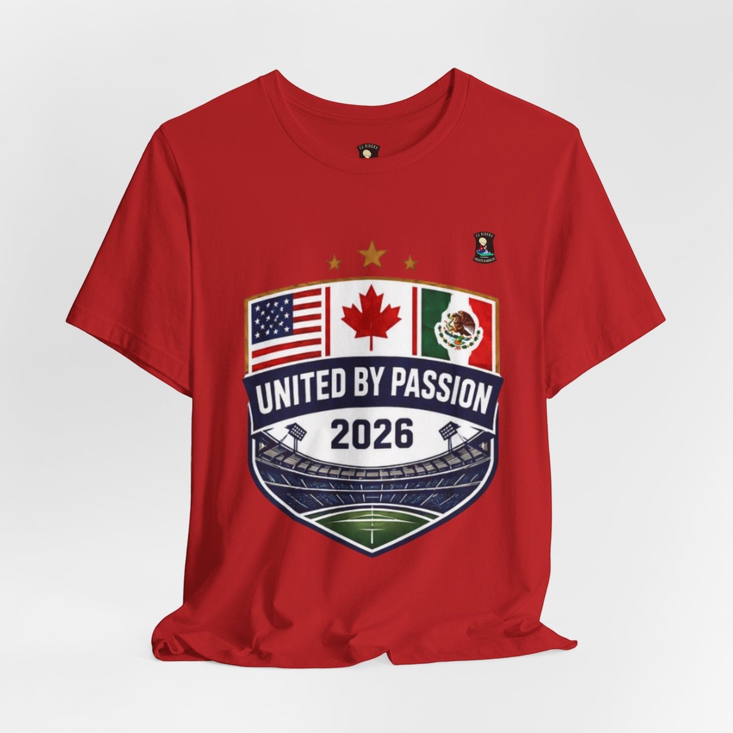 CJ Riders Foundation Store red 100% cotton t-shirt with United by Passion 2026 shield graphic featuring USA, Canada, and Mexico flags.