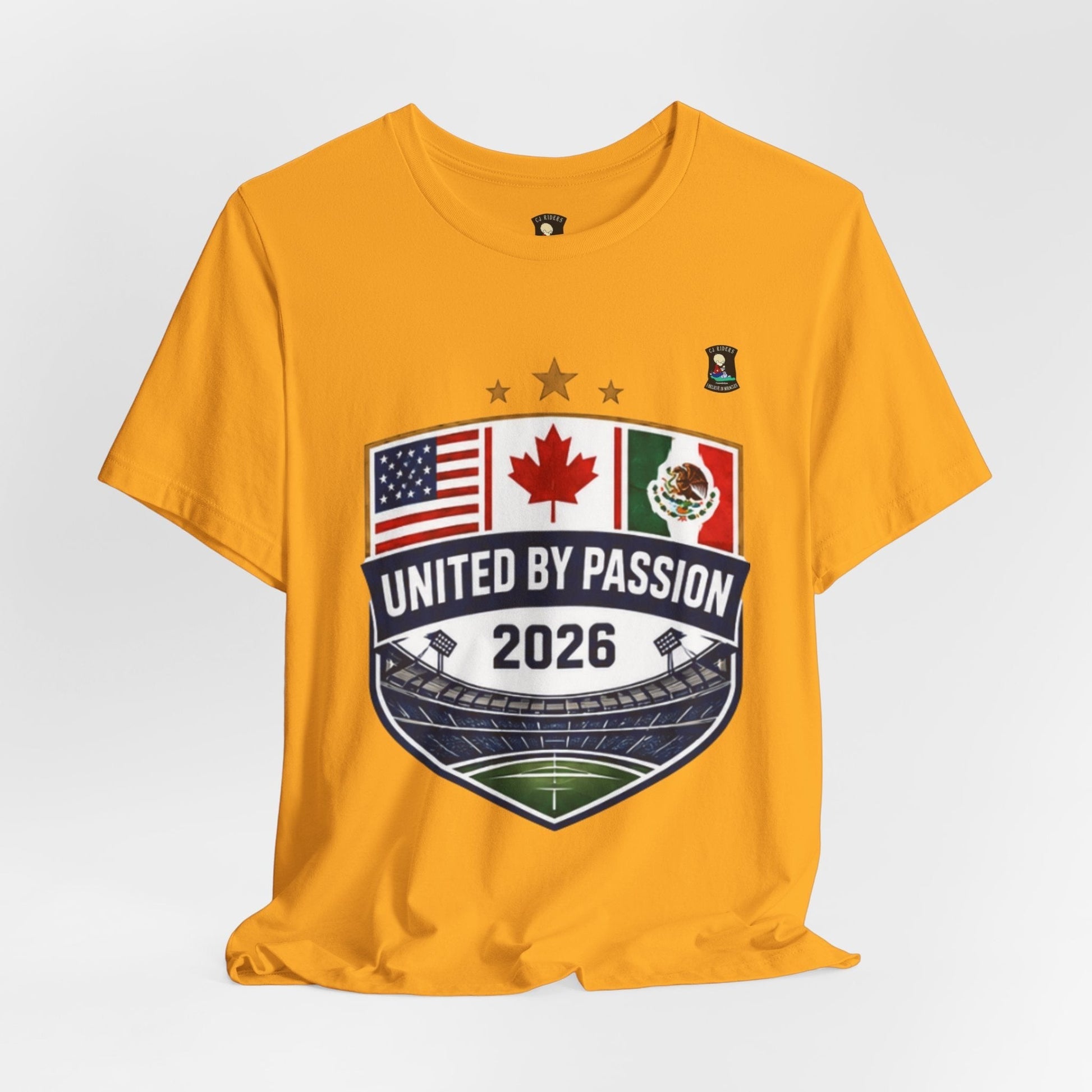 CJ Riders Foundation Store yellow 100% cotton t-shirt with United by Passion 2026 shield design featuring US, Canada, Mexico flags and stadium.