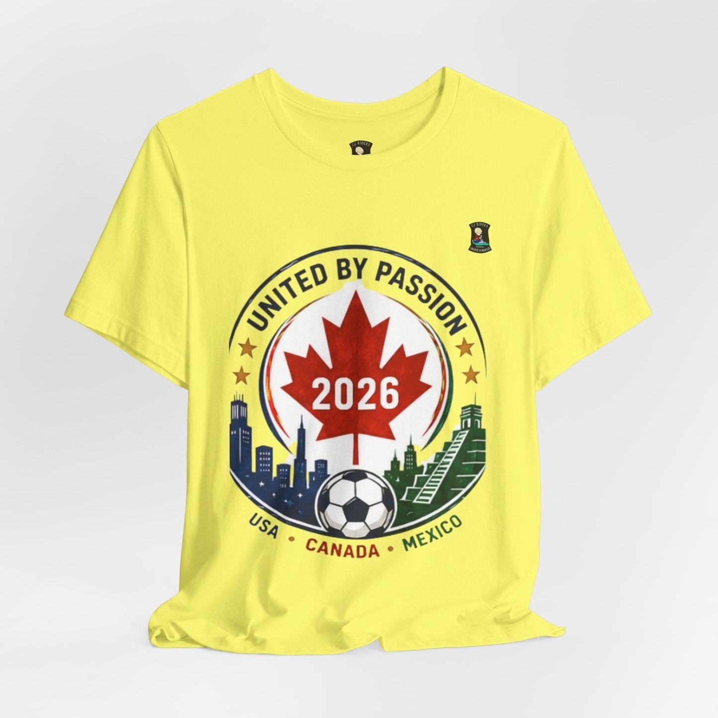 CJ Riders Foundation Store yellow 100% cotton t-shirt with a United by Passion 2026 soccer graphic featuring a Canadian maple leaf, soccer ball, and city skylines.