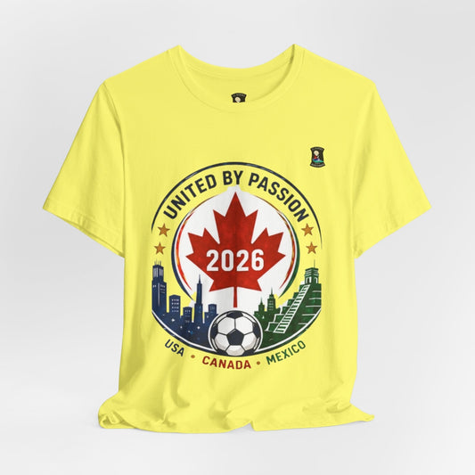 CJ Riders Foundation Store yellow 100% cotton t-shirt with a United by Passion 2026 soccer graphic featuring a Canadian maple leaf, soccer ball, and city skylines.
