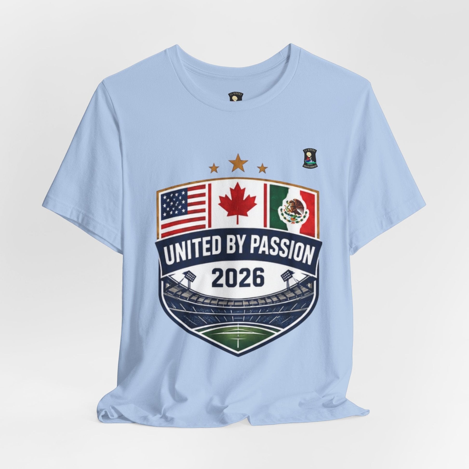 CJ Riders Foundation Store light blue 100% cotton t-shirt with United by Passion 2026 shield graphic featuring US, Canadian, and Mexican flags.