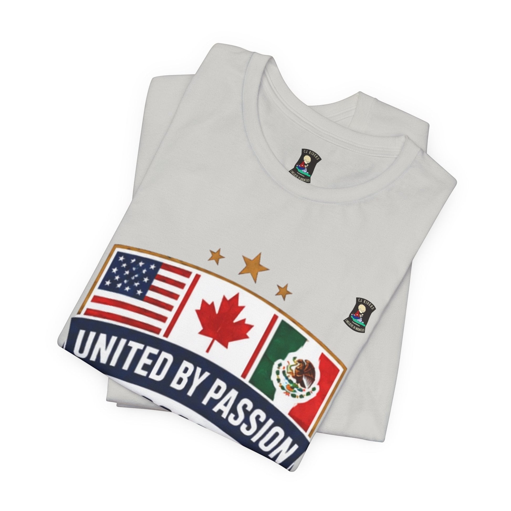 White 100% cotton t-shirt from CJ Riders Foundation Store with a shield design featuring US, Canadian, and Mexican flags and "United by Passion" text.