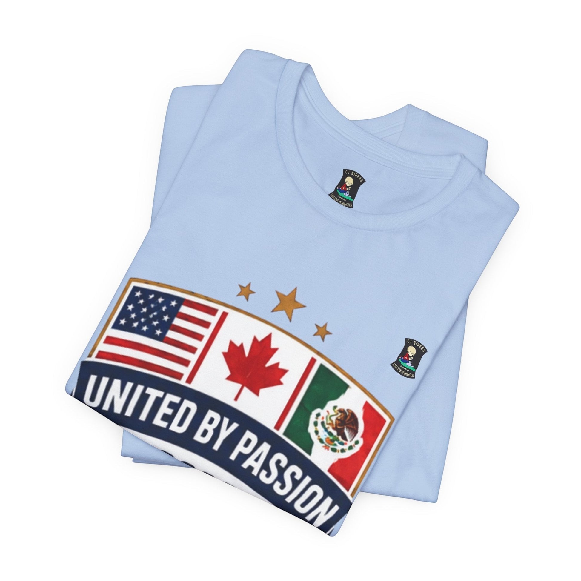 Light blue 100% cotton t-shirt from CJ Riders Foundation Store with a shield design featuring USA, Canada, and Mexico flags and "United by Passion" text.