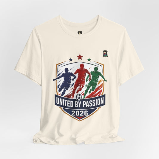 CJ Riders Foundation Store cream 100% cotton t-shirt with "United by Passion 2026" graphic featuring 3 soccer players and a ball.