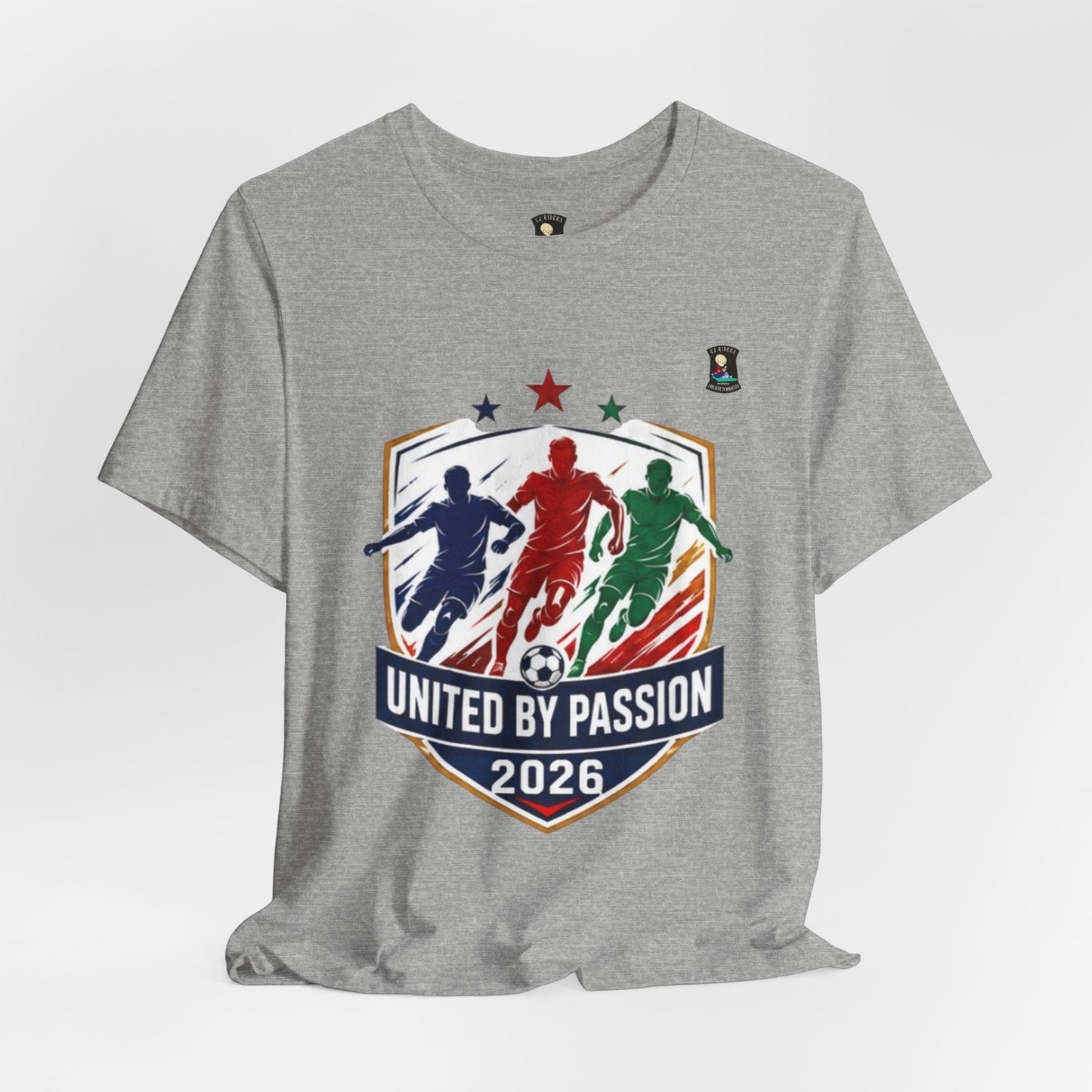 CJ Riders Foundation Store grey 100% cotton t-shirt with "United by Passion 2026" soccer graphic featuring 3 players and a soccer ball.
