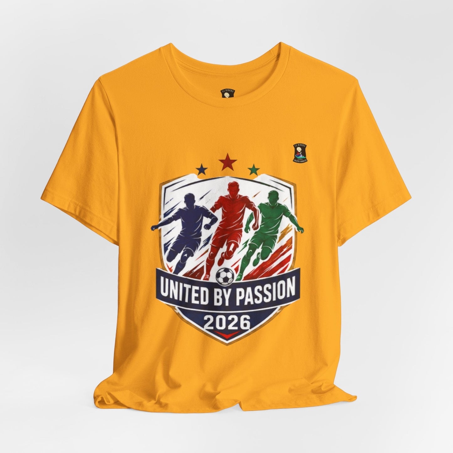 CJ Riders Foundation Store yellow cotton t-shirt with "United by Passion 2026" graphic featuring 3 soccer players and a ball.