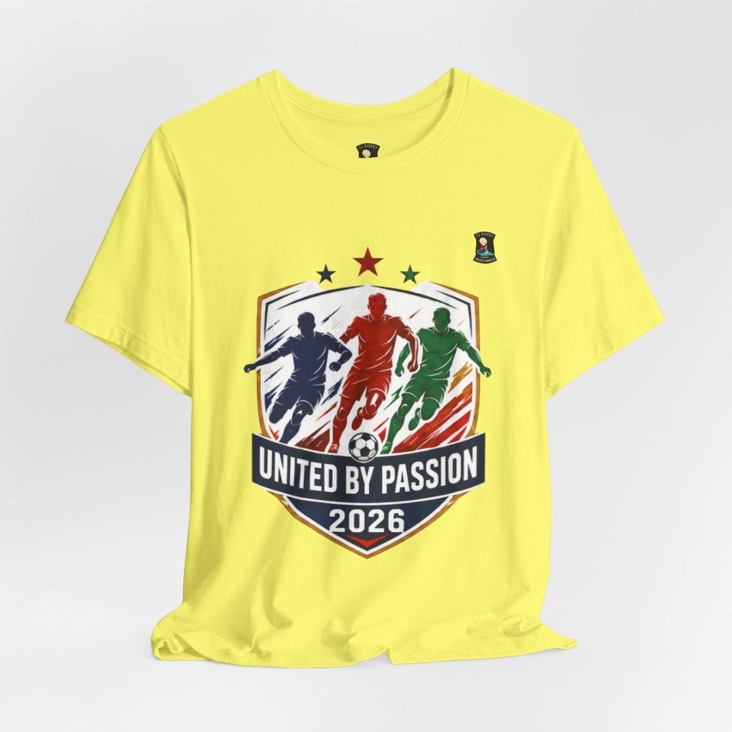 CJ Riders Foundation Store yellow 100% cotton t-shirt with "United by Passion 2026" soccer graphic.