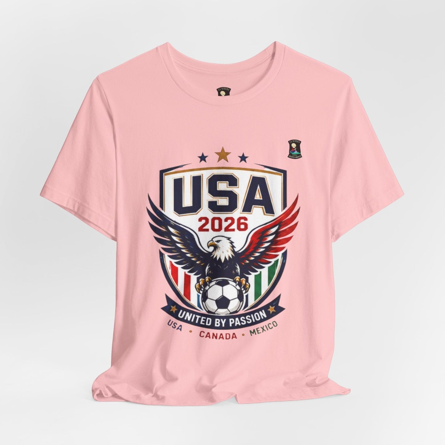 CJ Riders Foundation Store pink cotton t-shirt with USA 2026 soccer graphic featuring an eagle and soccer ball.