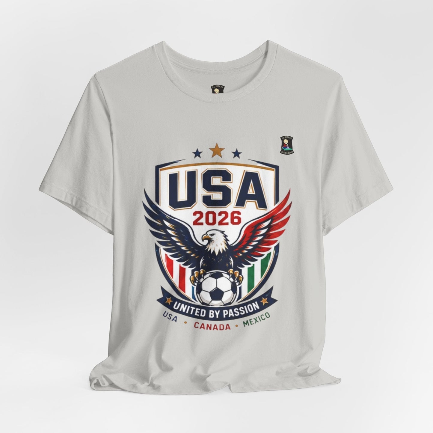 CJ Riders Foundation Store light grey 100% cotton t-shirt with USA 2026 soccer graphic featuring an eagle and soccer ball.