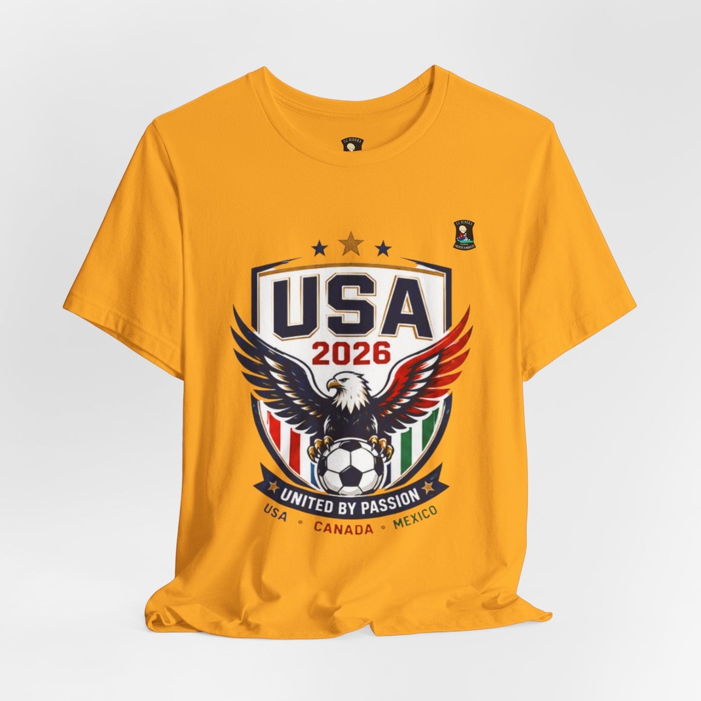 CJ Riders Foundation Store yellow 100% cotton t-shirt with USA 2026 soccer graphic featuring an eagle and soccer ball.