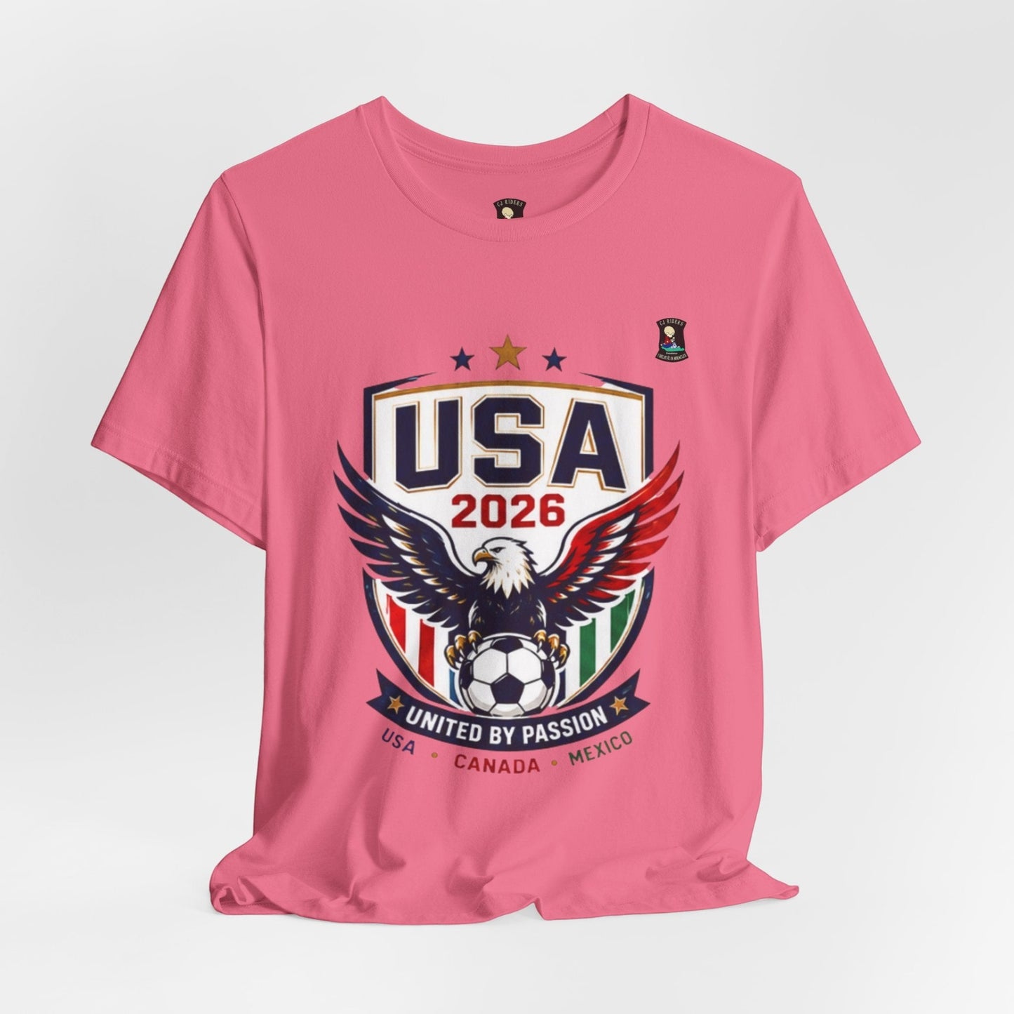 CJ Riders Foundation Store pink cotton t-shirt with USA 2026 eagle and soccer graphic.