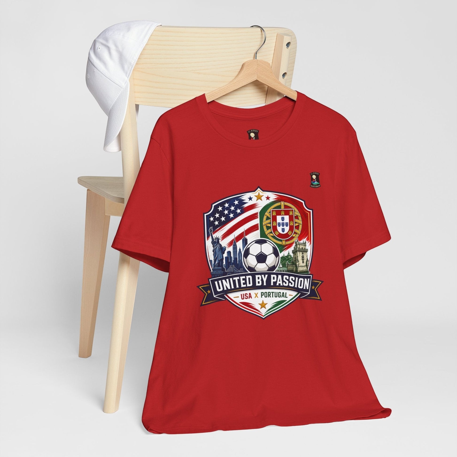 CJ Riders Foundation Store red cotton t-shirt with USA & Portugal soccer graphic and "United by Passion" text.