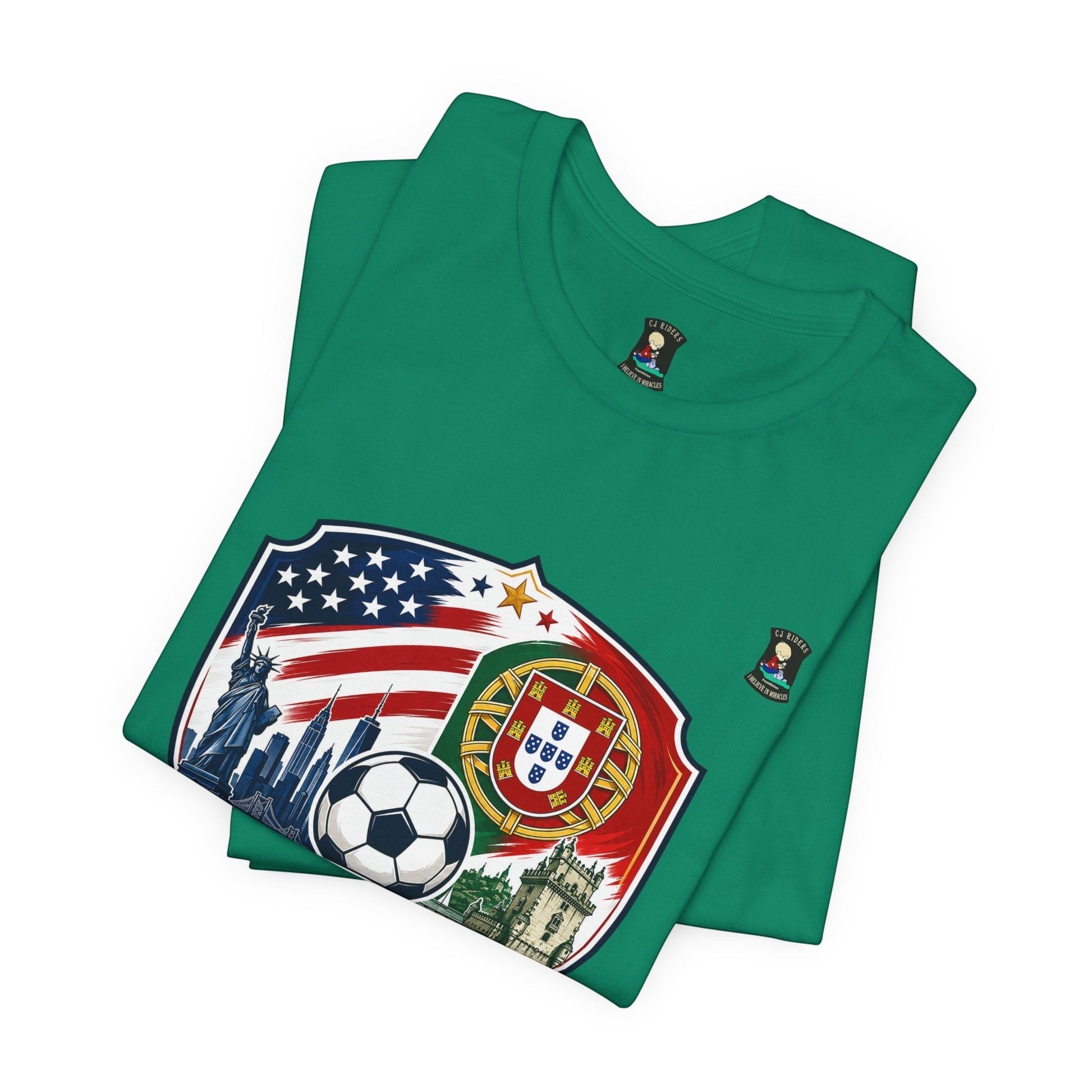 CJ Riders Foundation Store green 100% cotton t-shirt with USA & Portugal soccer graphic. Features US flag, Statue of Liberty, NYC skyline, soccer ball, Portugal crest, and castle.
