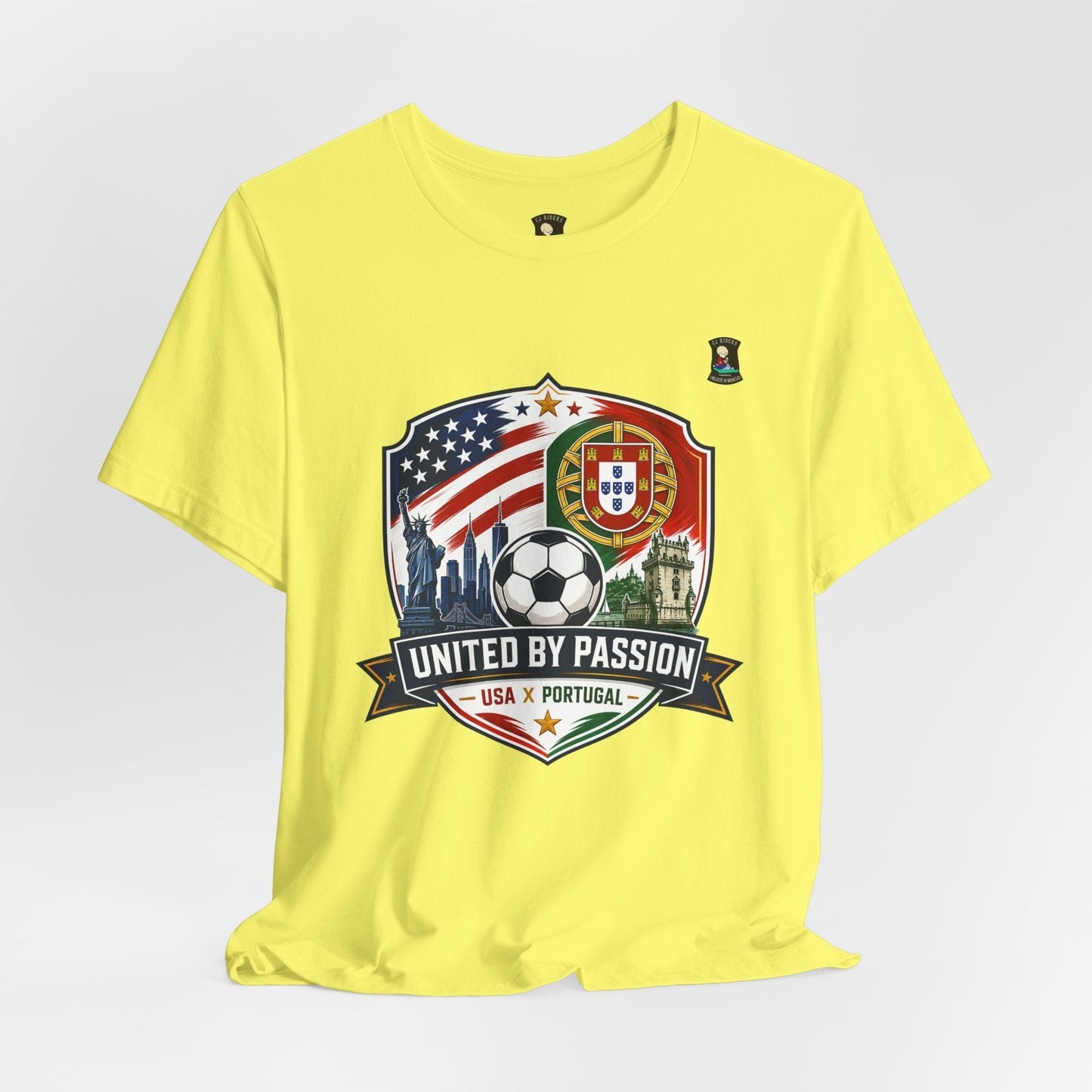 CJ Riders Foundation Store yellow 100% cotton t-shirt with USA & Portugal soccer badge graphic, Statue of Liberty, and skyline.