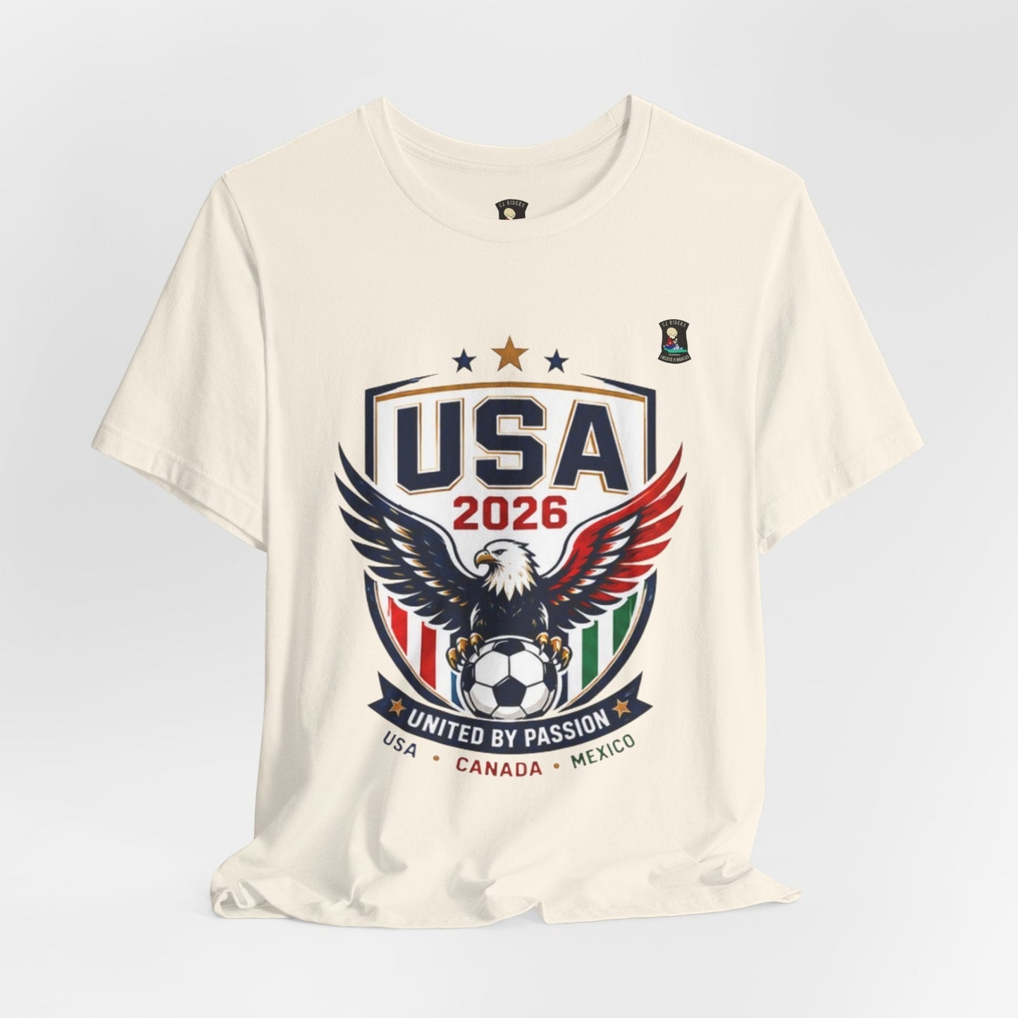 CJ Riders Foundation Store cream 100% cotton USA United by Passion 2026 soccer t-shirt with eagle graphic.